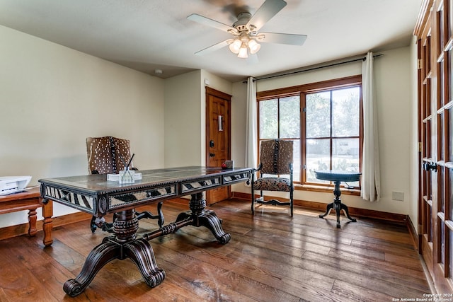 office area with baseboards, a ceiling fan, and dark wood-style floors