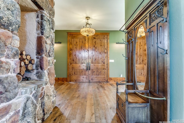 entrance foyer with baseboards and wood-type flooring