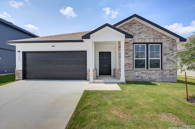 view of front of home featuring a garage and a front lawn