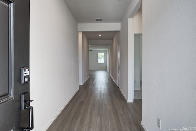 hallway with dark wood-type flooring