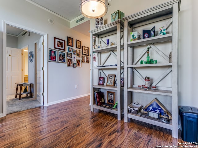 interior space with ornamental molding and dark wood-type flooring