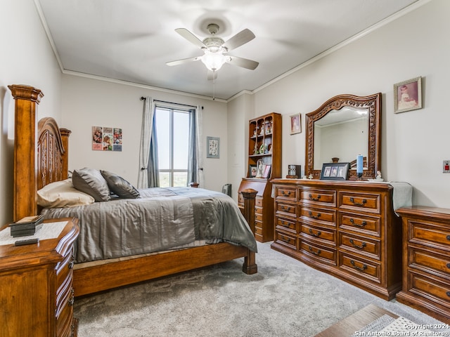 carpeted bedroom with crown molding and ceiling fan