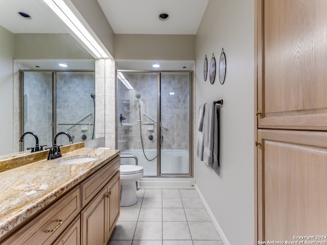 bathroom with vanity, toilet, tile patterned floors, and an enclosed shower