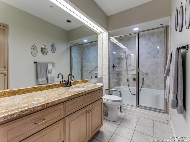 bathroom with tile patterned floors, walk in shower, vanity, and toilet