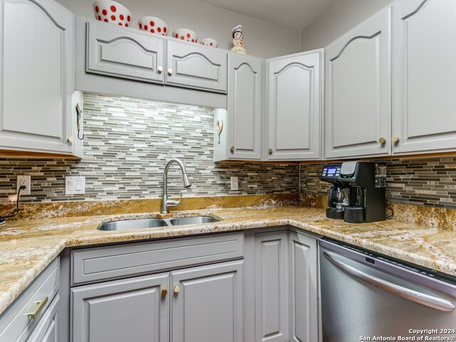 kitchen featuring stainless steel dishwasher and white cabinets