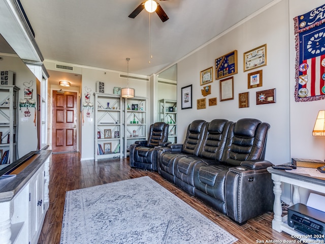 living room featuring ornamental molding, ceiling fan, and dark wood-type flooring