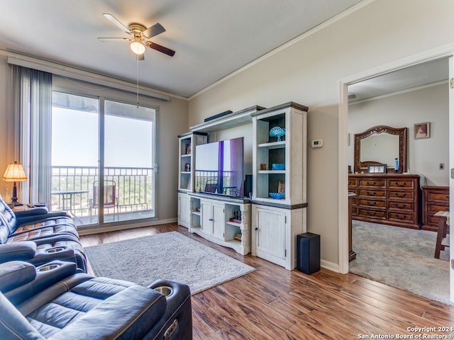 living room featuring ceiling fan, hardwood / wood-style floors, and crown molding