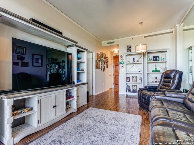 living room featuring ornamental molding and dark wood-type flooring