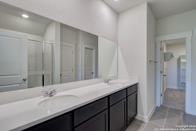 bathroom with vanity, a shower with door, and tile patterned floors