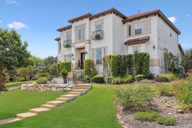 mediterranean / spanish-style home featuring a front yard