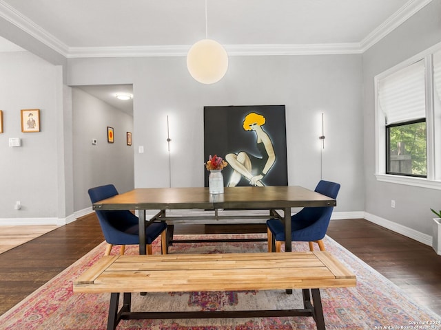 dining area featuring dark wood-type flooring and ornamental molding