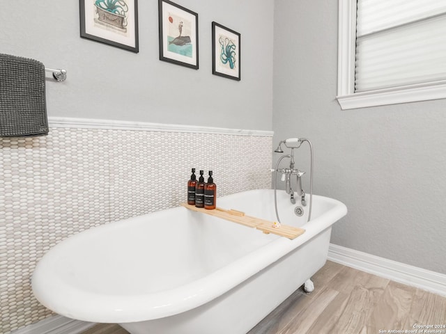 bathroom with tile walls and a bath