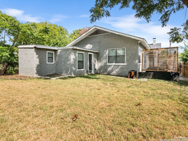 rear view of house with a yard