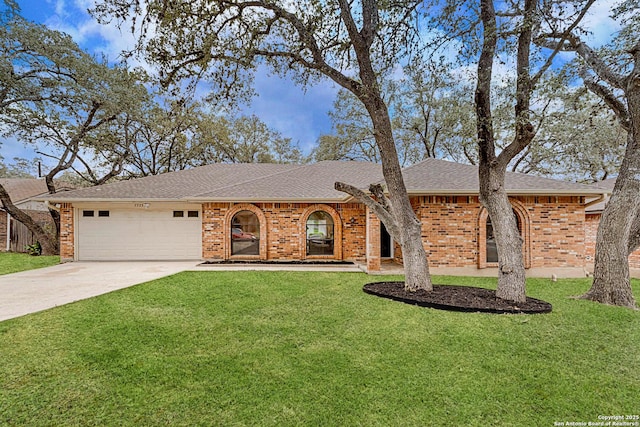 ranch-style house with a garage and a front lawn