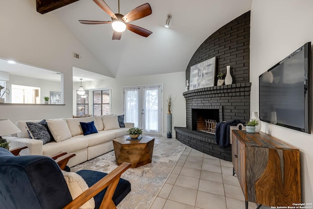 living room with a fireplace, light tile patterned floors, high vaulted ceiling, french doors, and ceiling fan