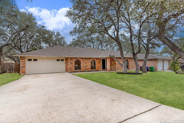 ranch-style home with a garage and a front yard