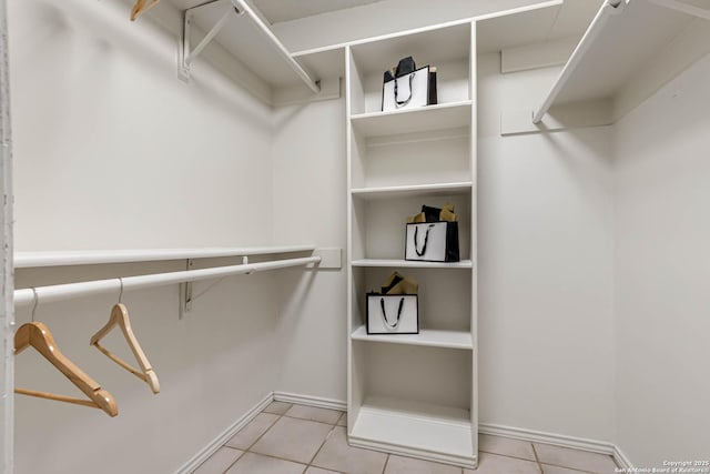 spacious closet with light tile patterned floors