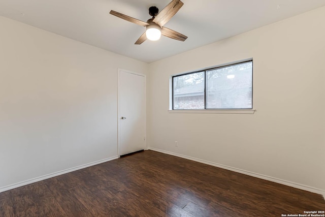 spare room featuring ceiling fan and dark hardwood / wood-style flooring