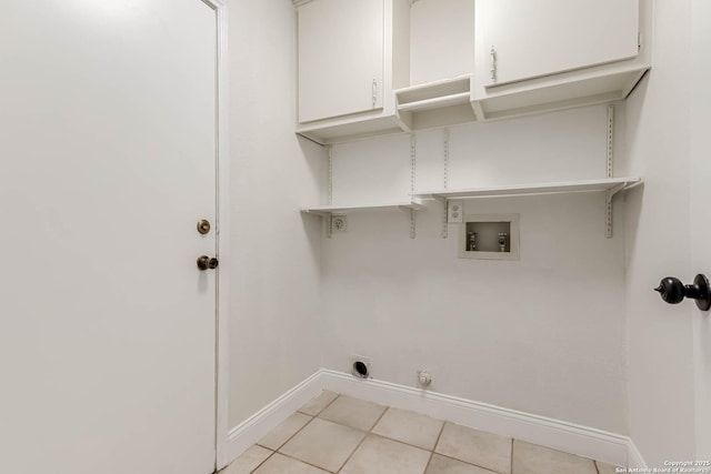 clothes washing area featuring washer hookup, electric dryer hookup, hookup for a gas dryer, cabinets, and light tile patterned flooring