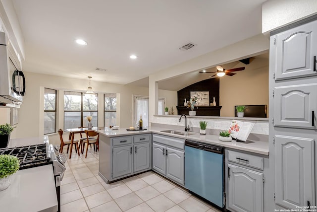 kitchen featuring appliances with stainless steel finishes, sink, kitchen peninsula, light tile patterned flooring, and gray cabinetry