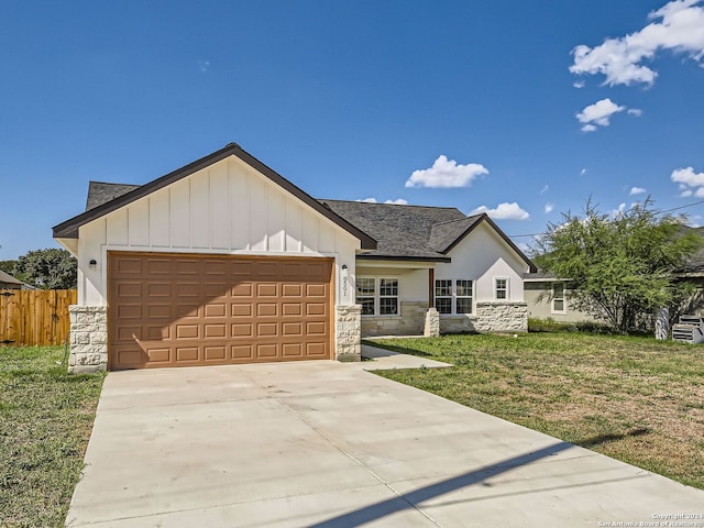 view of front of property featuring a garage and a front lawn