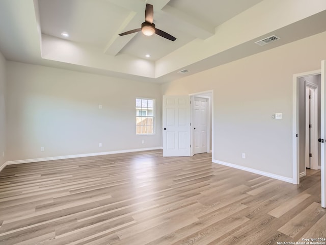 spare room featuring beamed ceiling, ceiling fan, and light hardwood / wood-style flooring