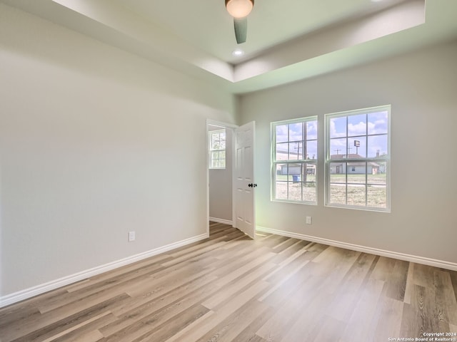 empty room with ceiling fan and light wood-type flooring