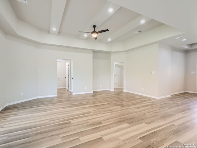 unfurnished room with ceiling fan, light hardwood / wood-style flooring, and a high ceiling