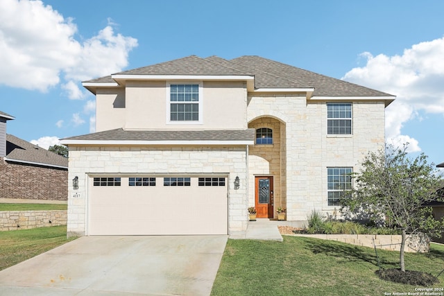 view of front of property featuring a garage and a front yard