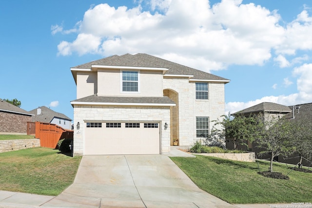 view of front of home with a garage and a front lawn