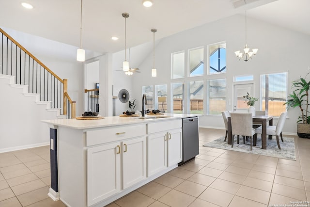 kitchen with dishwasher, sink, ceiling fan with notable chandelier, white cabinetry, and a center island with sink