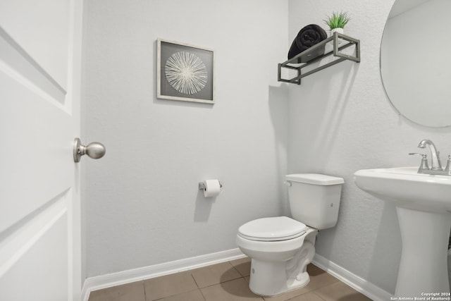 bathroom featuring sink, tile patterned flooring, and toilet