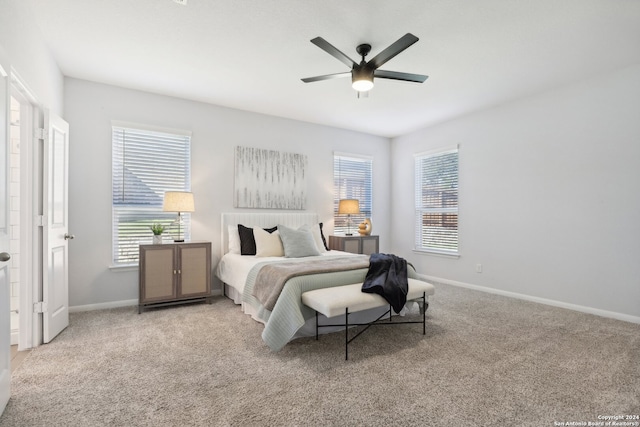 bedroom with ceiling fan and light colored carpet