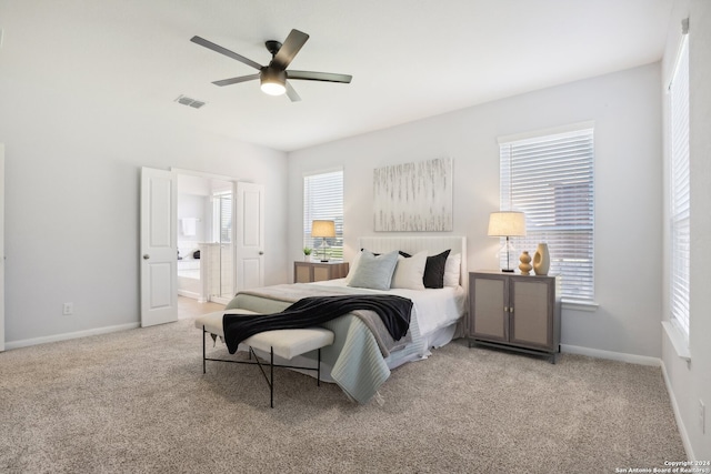 carpeted bedroom featuring ceiling fan and ensuite bathroom