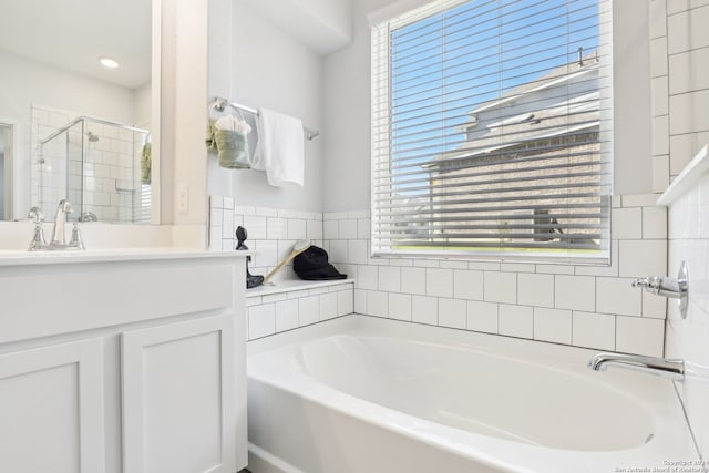 bathroom with independent shower and bath and vanity