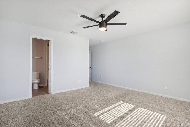 unfurnished bedroom with ceiling fan, connected bathroom, carpet flooring, a walk in closet, and a closet