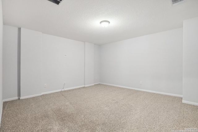 carpeted spare room with a textured ceiling