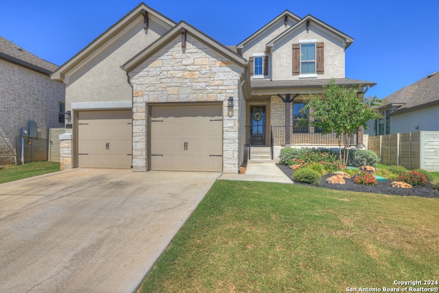 craftsman house with a garage, a front lawn, and covered porch