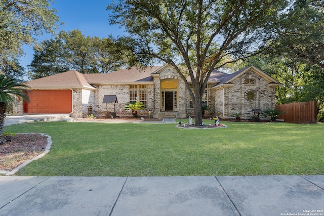 view of front of house with a garage and a front lawn