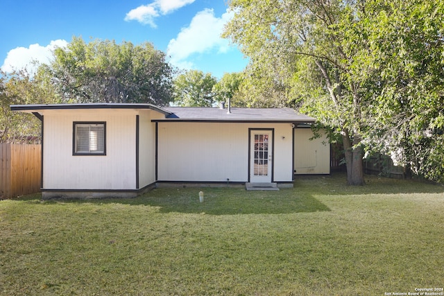 back of house with a lawn