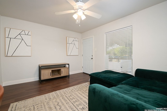 living room featuring dark hardwood / wood-style floors and ceiling fan