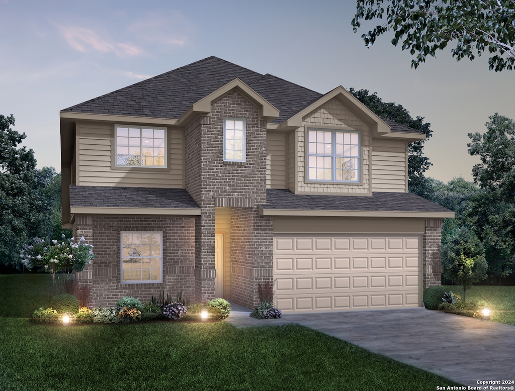 view of front of house featuring a lawn and a garage