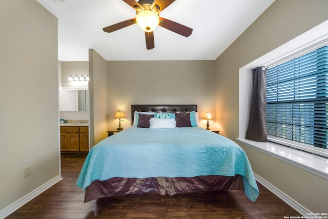 bedroom featuring ceiling fan, dark hardwood / wood-style floors, and ensuite bathroom