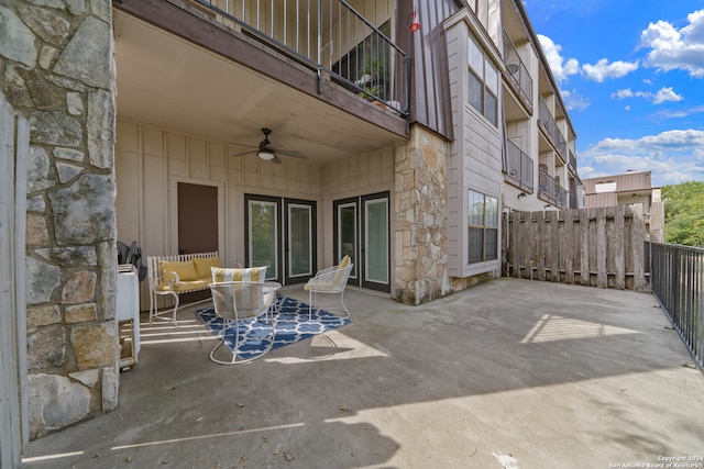 view of patio with a balcony and ceiling fan