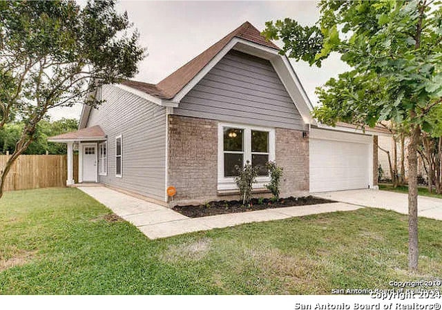 view of front of property with a front yard and a garage