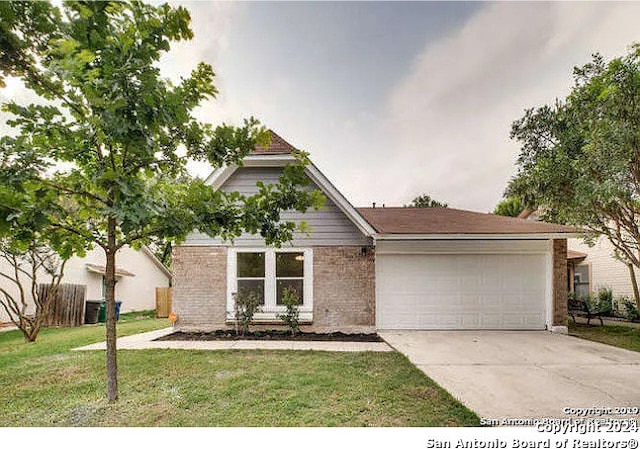 view of front facade with a garage and a front lawn