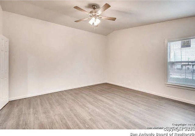 spare room featuring ceiling fan and dark hardwood / wood-style flooring