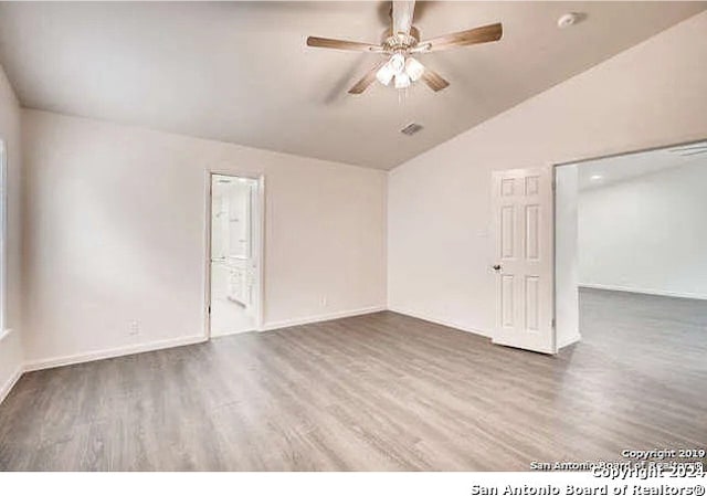 spare room featuring lofted ceiling, ceiling fan, and hardwood / wood-style flooring