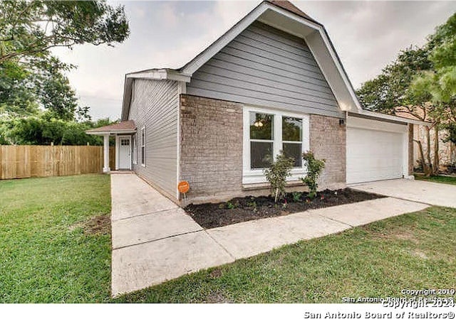 view of front facade with a front yard and a garage