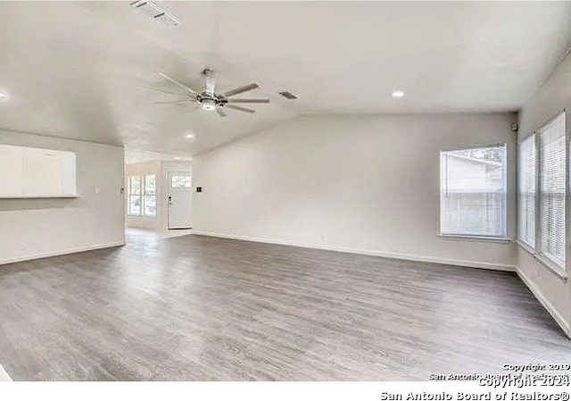 unfurnished living room with ceiling fan, lofted ceiling, and hardwood / wood-style floors